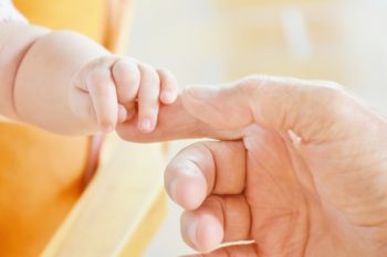 father and child baby hands