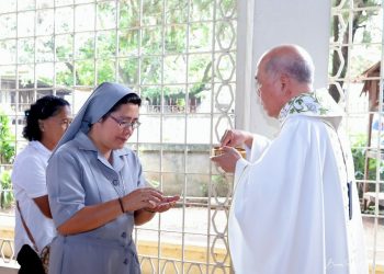 Communion by the hand Abp Valles