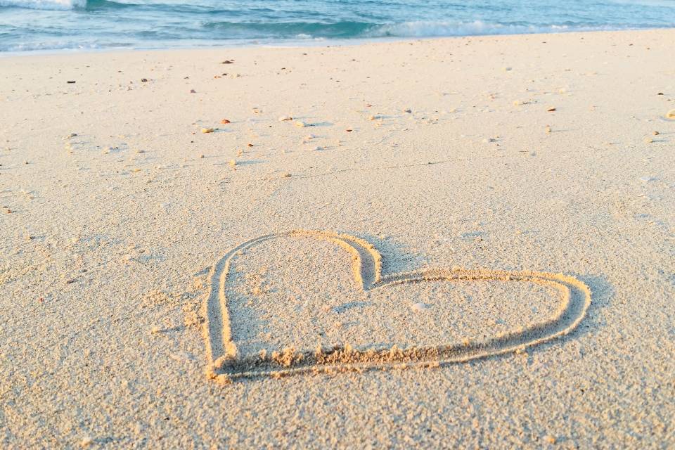 khadeeja yasser stock heart on sand beach unsplash