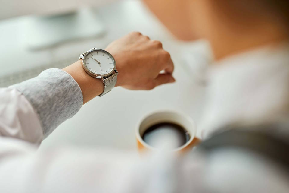 woman looking at time watch stock