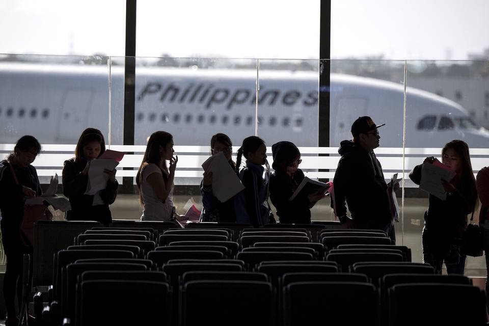 OFW returning home Philippines airport stock