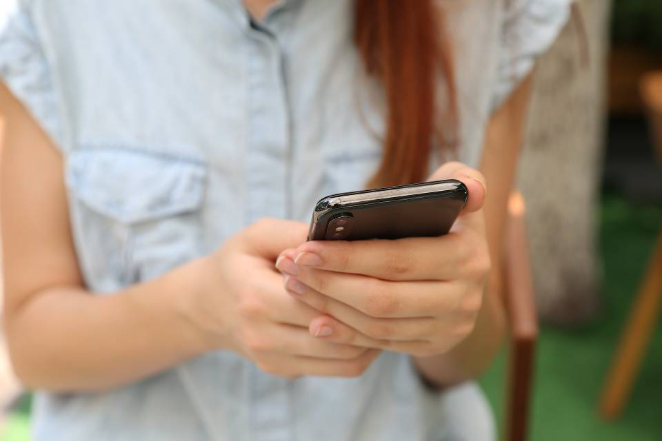 Yura Fresh stock woman holding cellphone unsplash