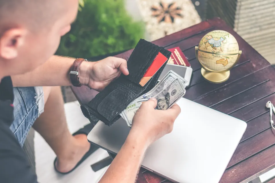 Man counting money stock by Artem Beliaikin on unsplash